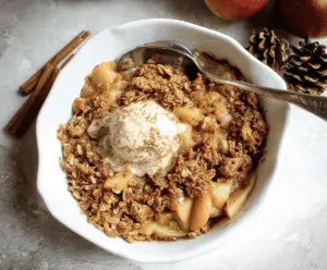 Delicious homemade almond flour apple crisp topped with golden brown crust and fresh apple slices, perfect for a healthy dessert.