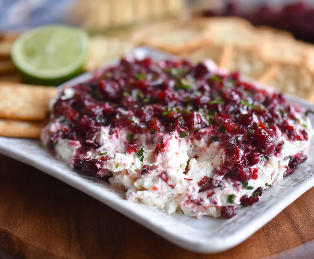Creamy cranberry and jalapeño cream cheese dip served with fresh vegetables.
