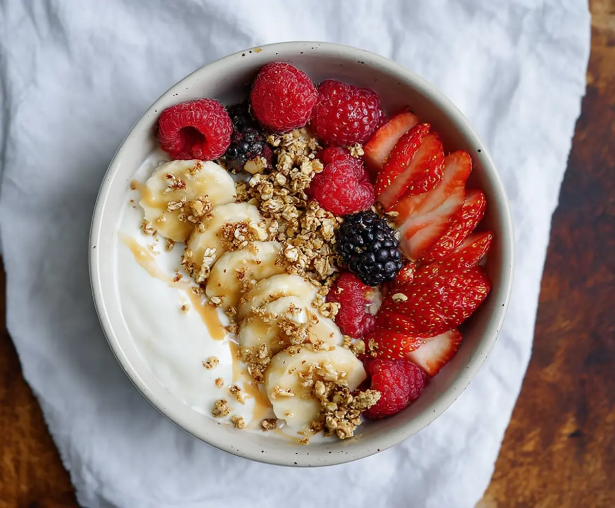 Healthy protein yogurt bowl topped with fresh berries and granola for a nutritious breakfast.