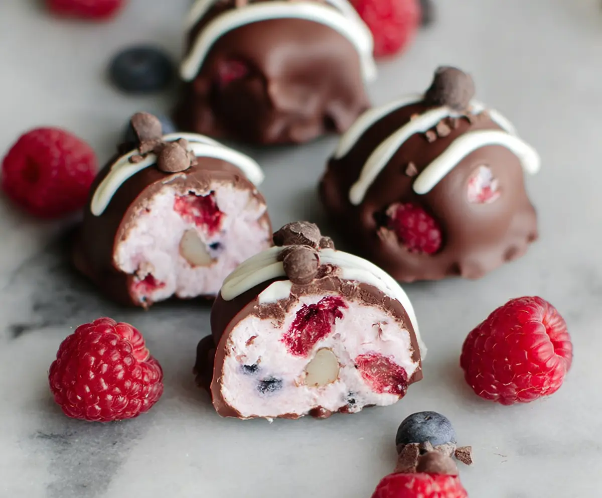 Delicious Raspberry Dark Chocolate Yogurt Bites on a platter, showcasing their creamy texture and vibrant berry color.