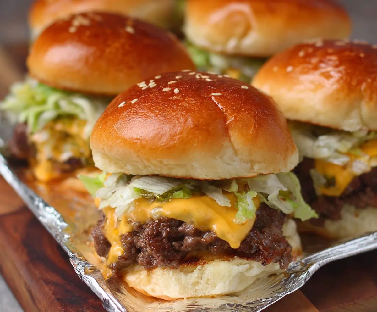 Delicious Beefy and Big Mac Sliders with juicy beef patties, fresh lettuce, and melted cheese on sandwiched buns.