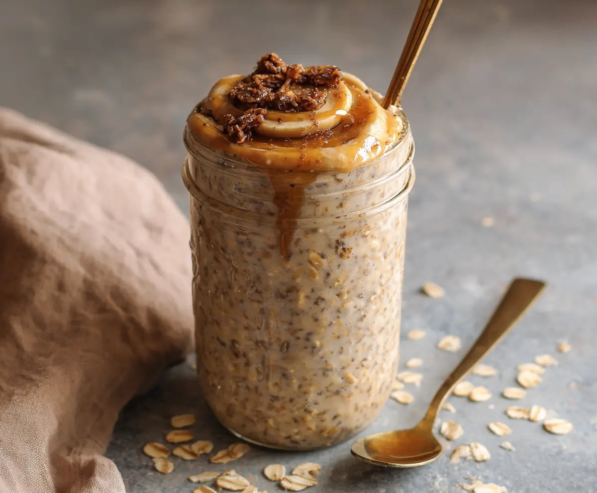 Creamy brown sugar espresso overnight oats in a jar topped with coffee beans and chocolate shavings perfect for a hearty breakfast.