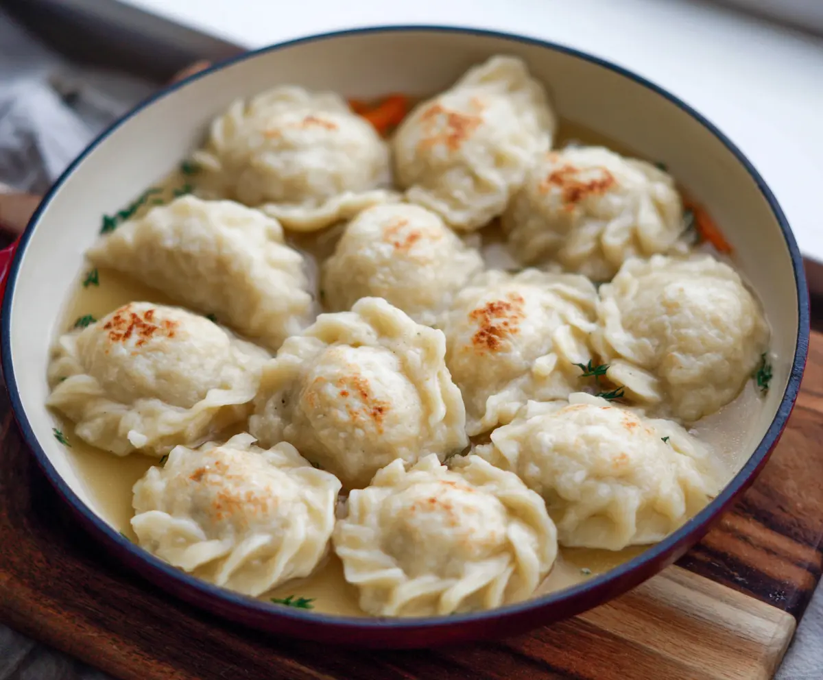 Delicious sourdough discard dumplings served on a rustic plate, showcasing crispy edges and fluffy interior.