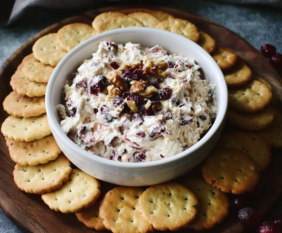 Creamy cranberry walnut cream cheese dip served with fresh fruit and crackers.
