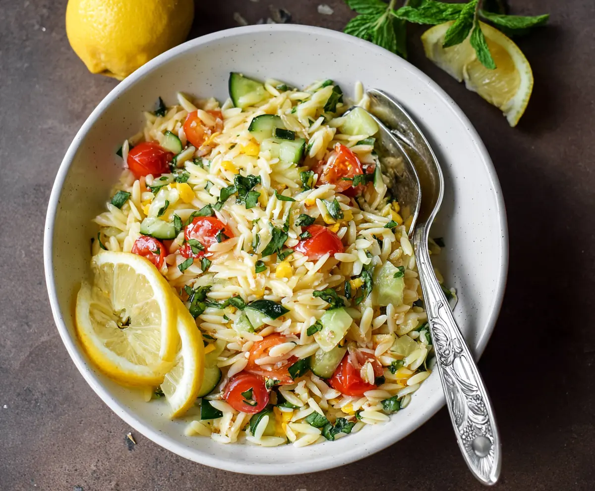 Fresh Lemon Orzo Pasta Salad with herbs and vegetables, perfect for summer picnics.